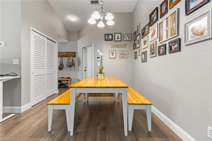 Dining area with wood-type flooring and a chandelier