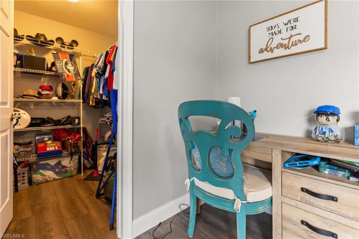 Spacious closet featuring hardwood / wood-style flooring