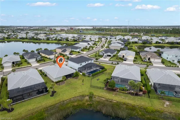 Aerial view of residential area featuring a large body of water