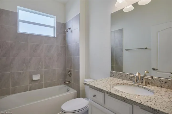Full bath with vanity and shower / tub combination