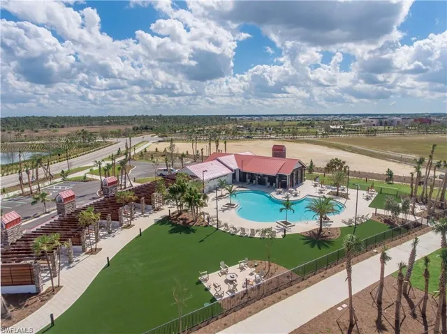 Community pool featuring a patio area, fire pits and cabanas for rent