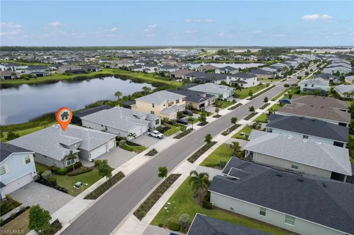 Aerial perspective of suburban area with a nearby body of water