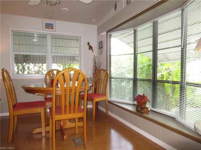Dining room featuring healthy amount of natural light, wood finished floors, and a ceiling fan