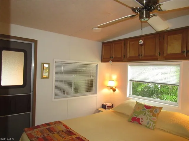 Bedroom with lofted ceiling and ceiling fan