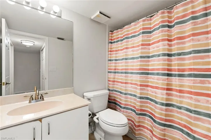 The guest side enjoys its own bathroom, cabinet fronts have been  replaced, not reflected in photo.