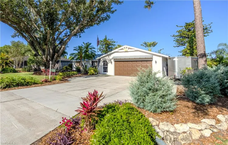 Ranch-style home featuring a garage, stucco siding, and concrete driveway