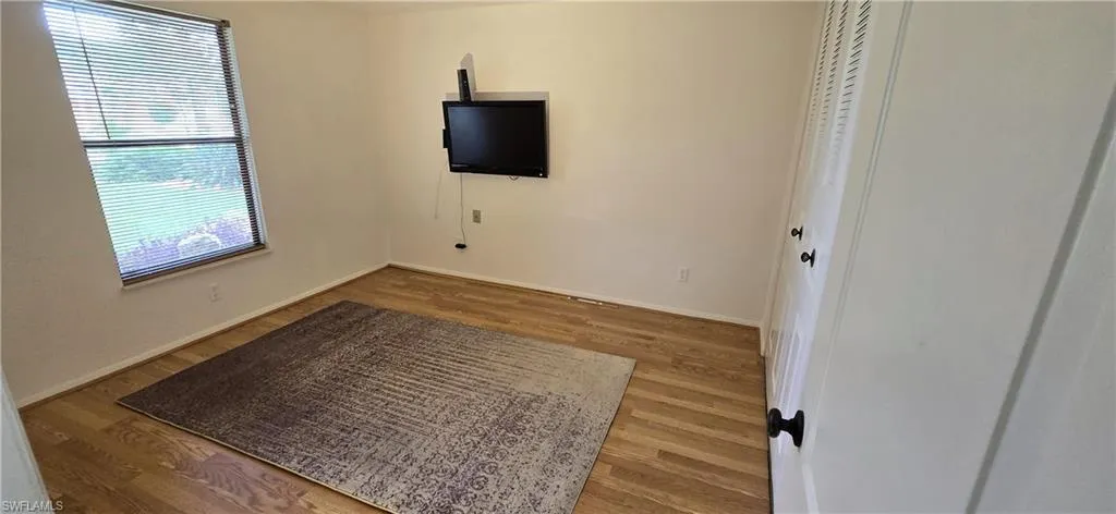 Spare room with wood finished floors and baseboards