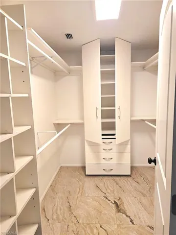 Spacious closet with marble finish flooring