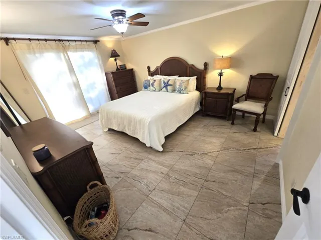 Bedroom featuring ornamental molding and a ceiling fan