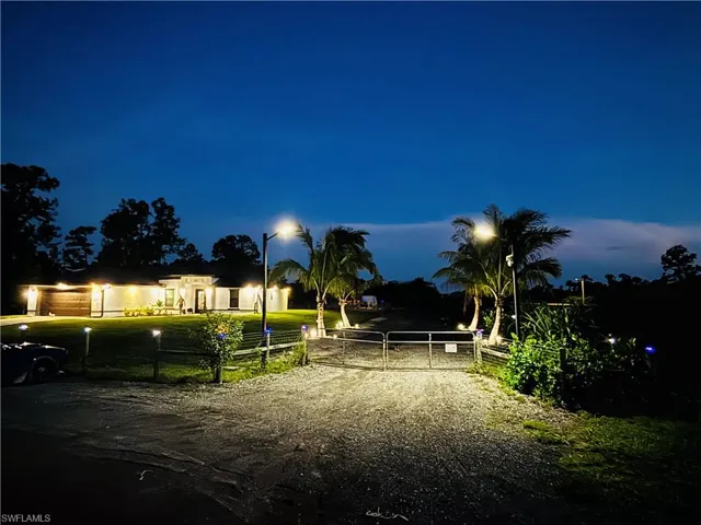 View of dirt / gravel road featuring a gate and a gated entry