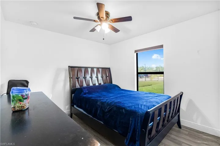 Bedroom with wood-type flooring and ceiling fan