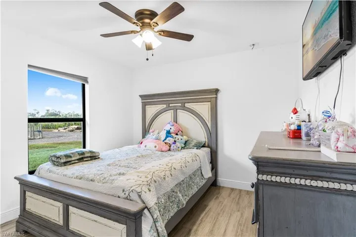 Bedroom featuring ceiling fan and light hardwood / wood-style flooring