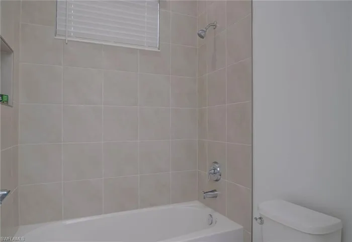 Bathroom with toilet and shower / tub combination