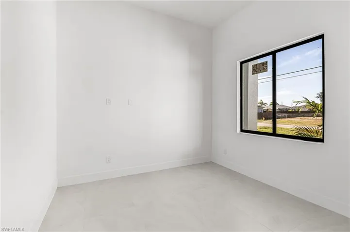 Unfurnished room with baseboards