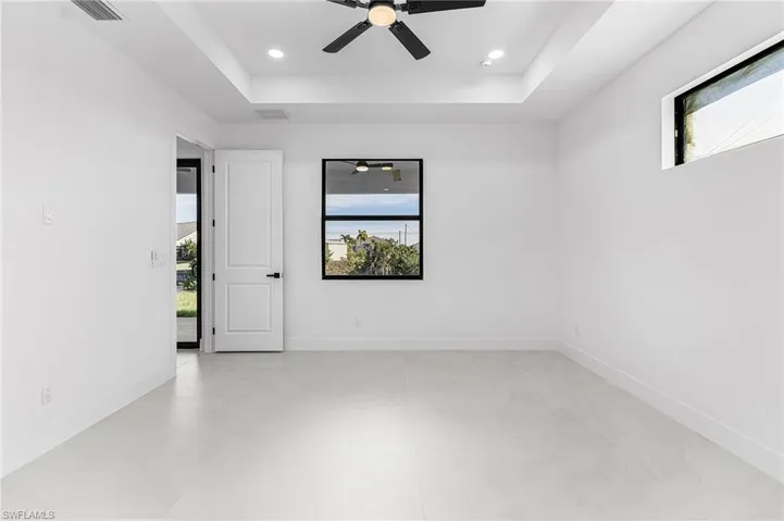Spare room with ceiling fan, recessed lighting, and a raised ceiling