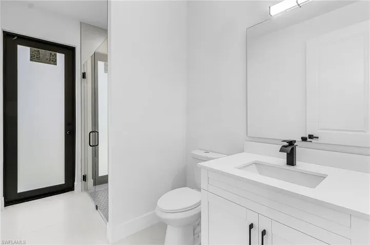 Bathroom featuring a stall shower and vanity