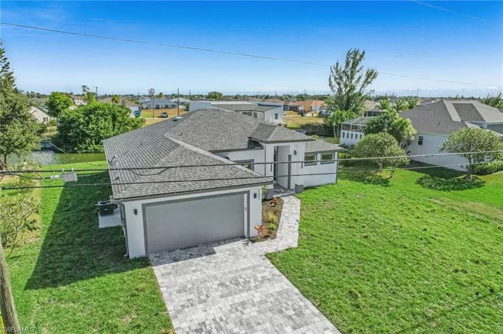 View of front of property with a residential view, roof with shingles, stucco siding, decorative driveway, and an attached garage
