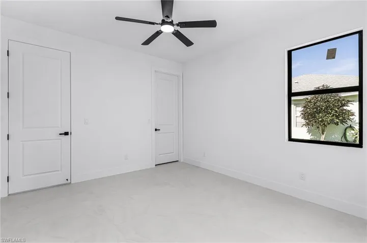 Unfurnished bedroom with ceiling fan and baseboards