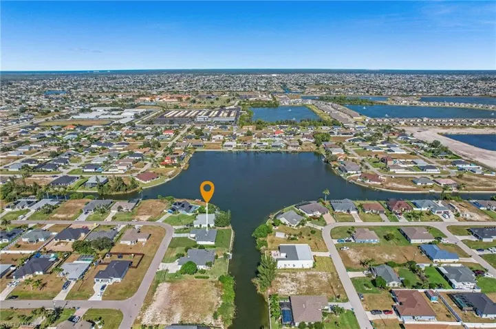 Aerial view of property's location with nearby suburban area and a nearby body of water