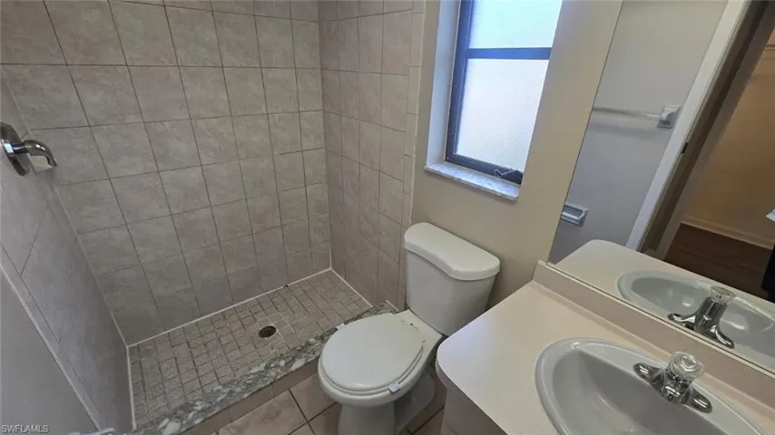 Bathroom featuring vanity, a stall shower, and tile patterned floors
