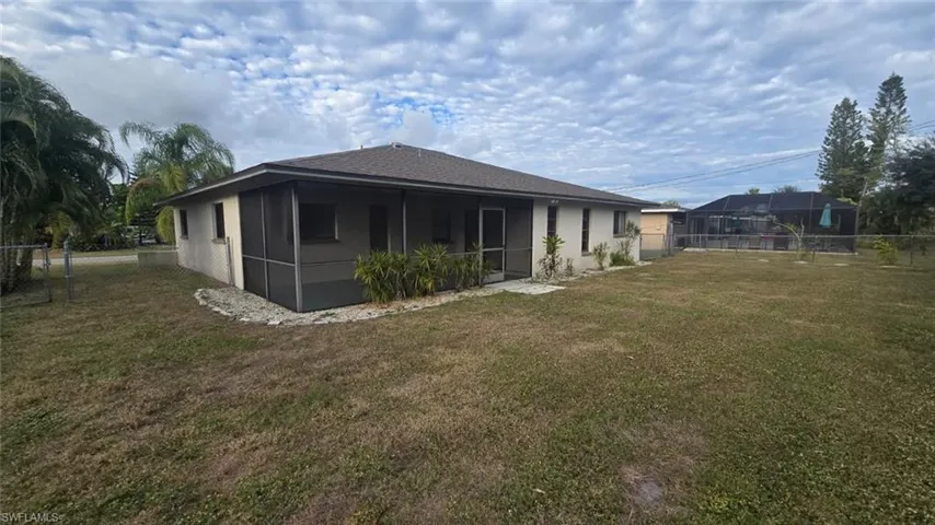 Rear view of property with a sunroom and stucco siding