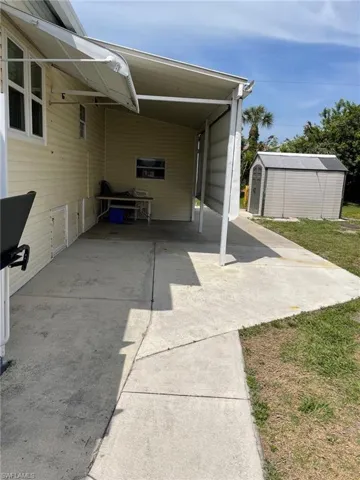 View of patio / terrace featuring a shed and a carport