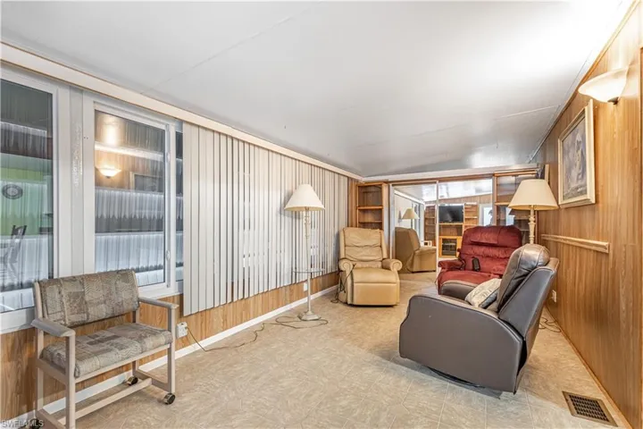 Living room featuring wooden walls