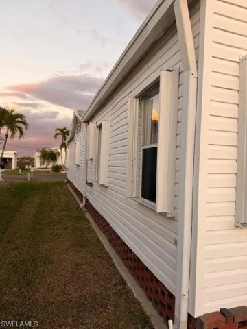 Property exterior at dusk with a lawn
