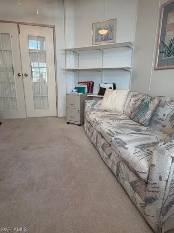 Living area with carpet floors and french doors