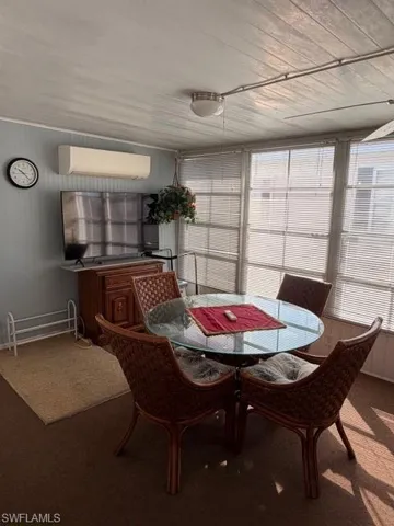 Sunroom with carpet flooring and plenty of natural light