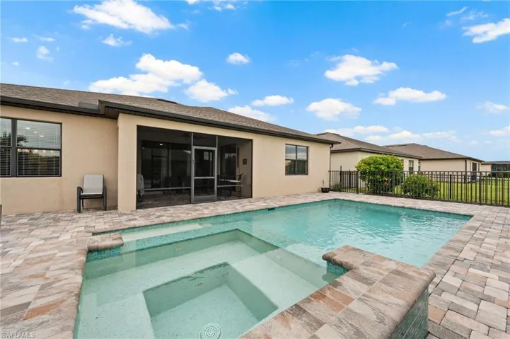 Screened patio with a built-in pool and integrated spa