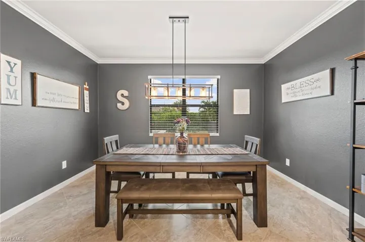 Recessed window with blinds, tile flooring, crown molding, and a modern linear chandelier