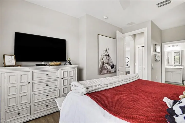 Bedroom featuring wood-finish flooring and light gray wall paint