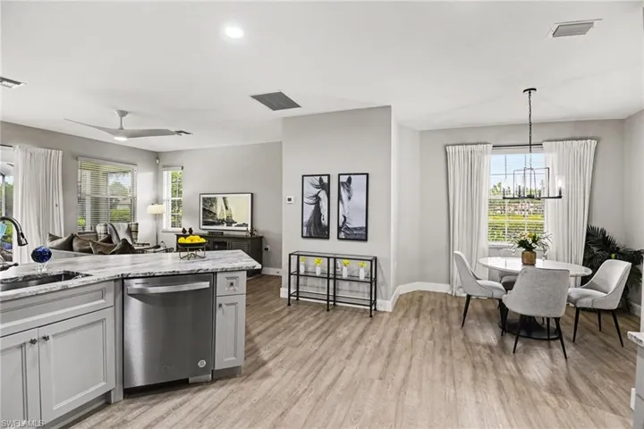 Open-concept living space featuring wood-finish flooring, recessed lighting, and a modern ceiling fan