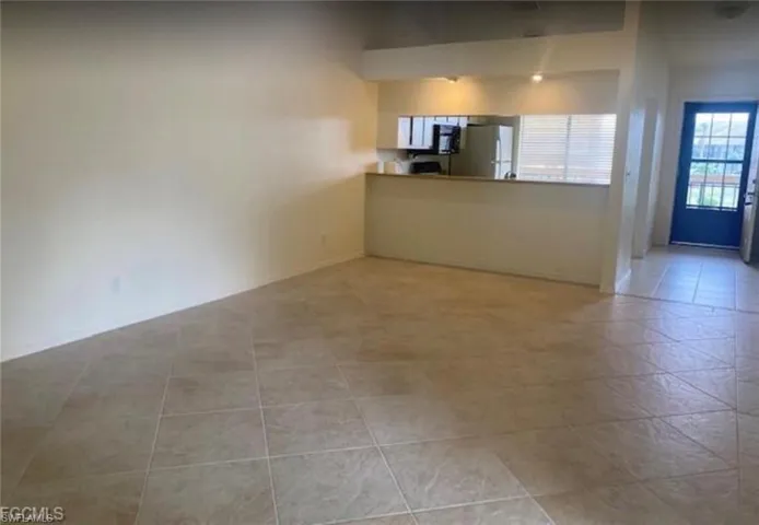 Unfurnished living room featuring light tile patterned flooring