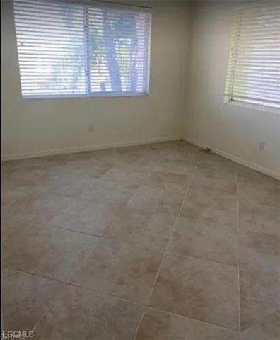 Spare room with plenty of natural light and light tile patterned floors
