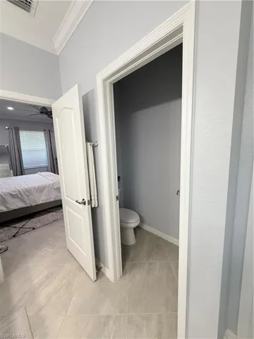 Bathroom with ensuite bathroom and crown molding