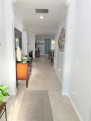 Corridor featuring ornamental molding and recessed lighting
