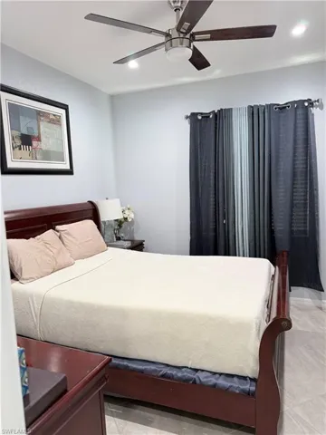 Bedroom with ceiling fan and recessed lighting