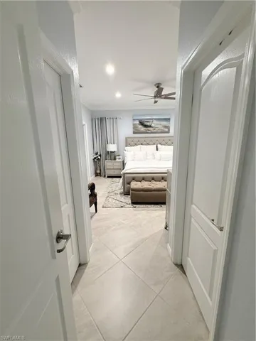 Bedroom with ornamental molding, ceiling fan, recessed lighting, and light tile patterned flooring