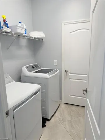 Laundry room with washer and clothes dryer