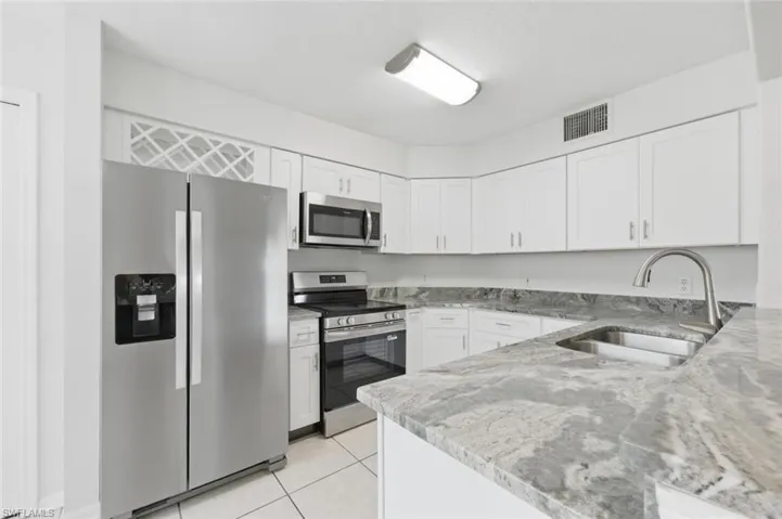 Kitchen featuring updated stainless steel appliances, countertops and cabinets