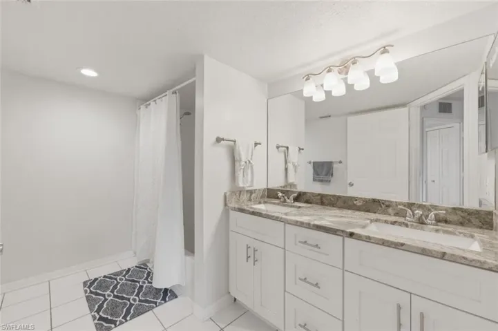 Primary Bathroom with double vanity and updated countertops & cabinets