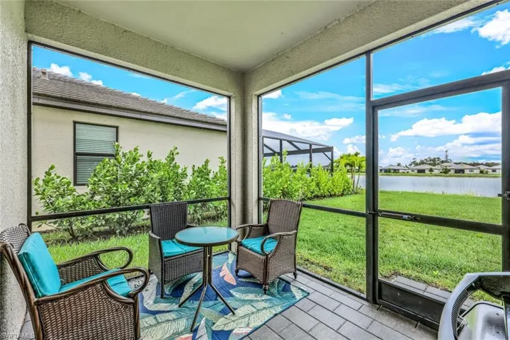 Sunroom / solarium featuring a water view