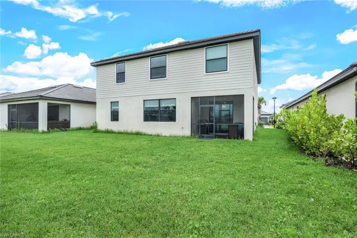 Rear view of house with a yard