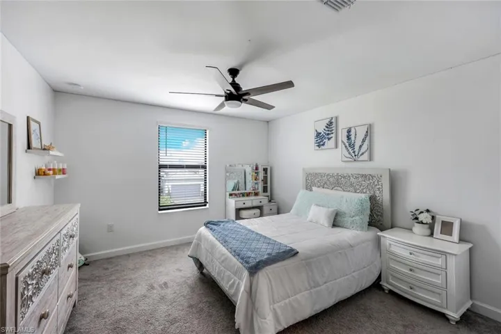 Bedroom featuring carpet and ceiling fan
