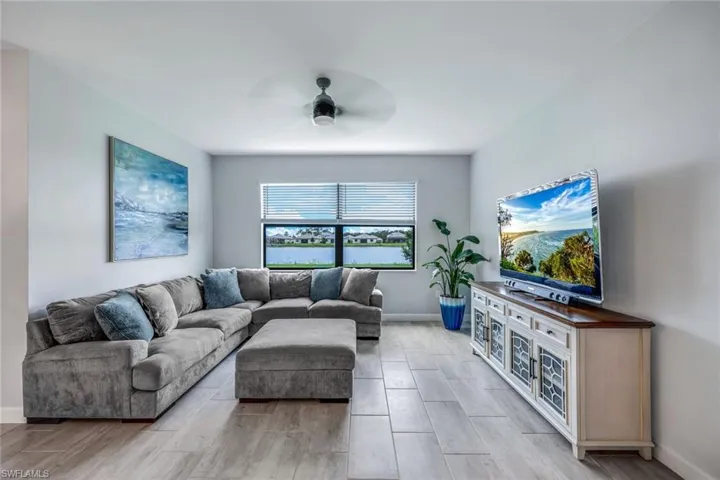 Living room featuring ceiling fan and light hardwood / wood-style flooring