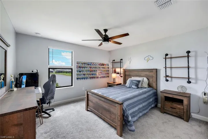 Carpeted bedroom with ceiling fan