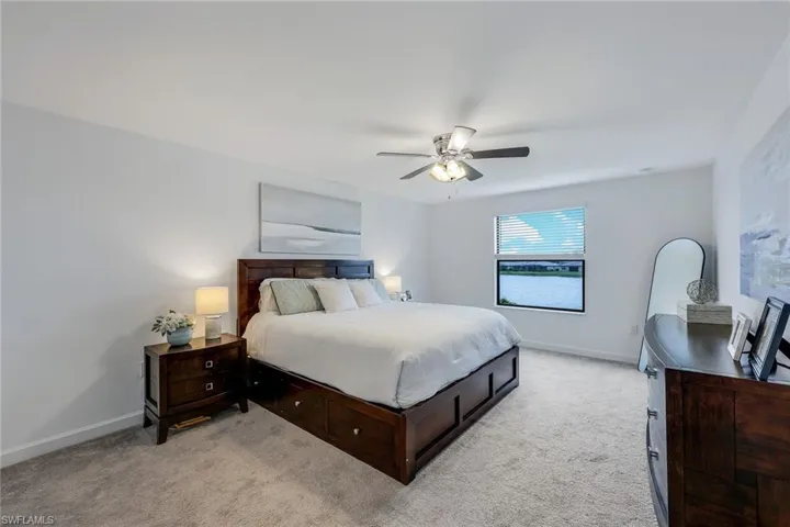 Bedroom featuring ceiling fan and light colored carpet