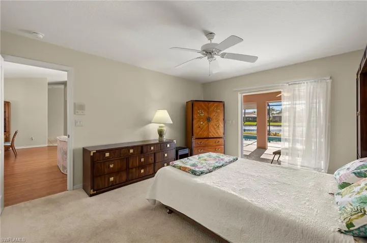 Master bedroom with sparkling lake and pool views.